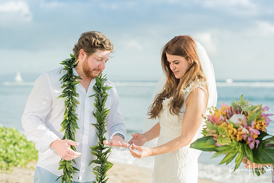 bride and groom exchanging rings at maui wedding