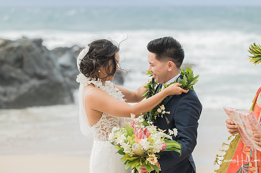 bride exchanging lei with groom at maui wedding