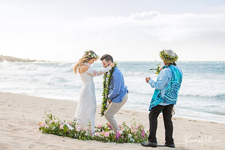bride exchanging lei with groom at hawaii marriage ceremony