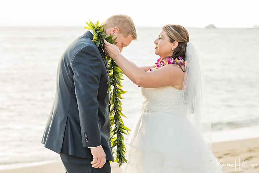 bride and groom exchanging leis at wedding