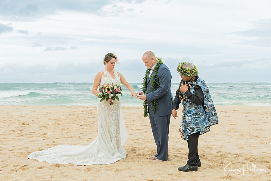 groom exchanging ring with bride at hawaii wedding
