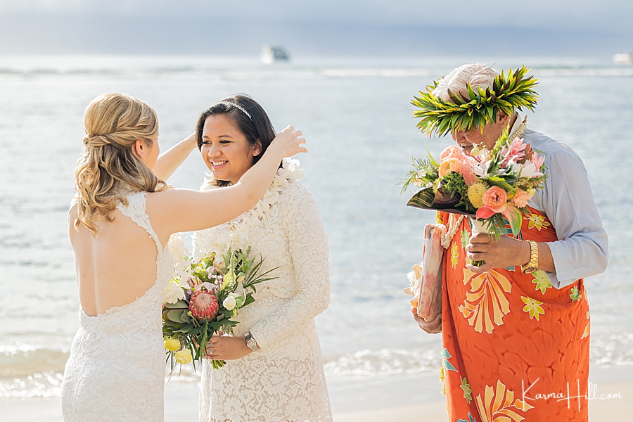 brides exchanging leis at hawaii wedding