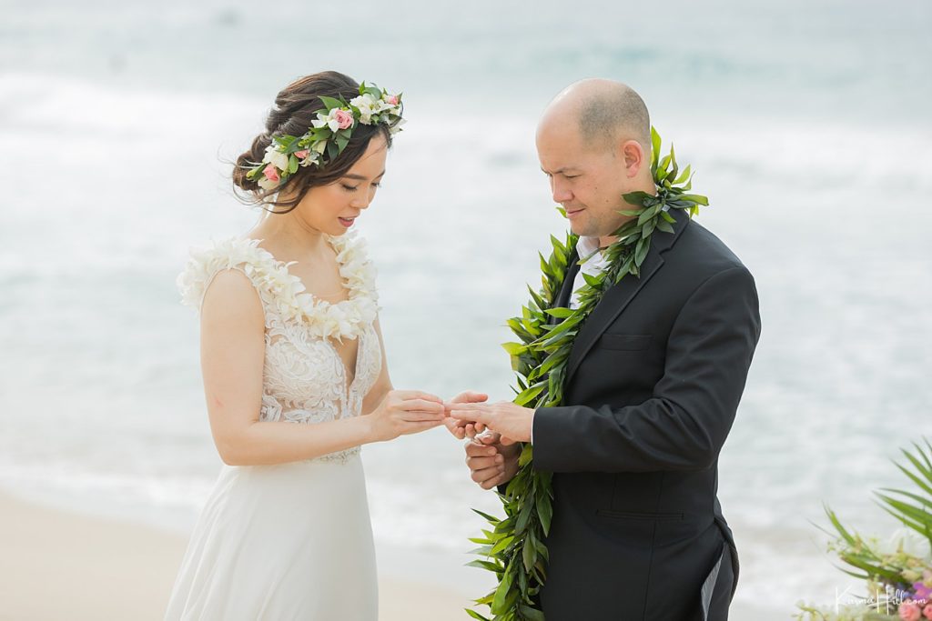 bride exchanging ring with groom at maui wedding