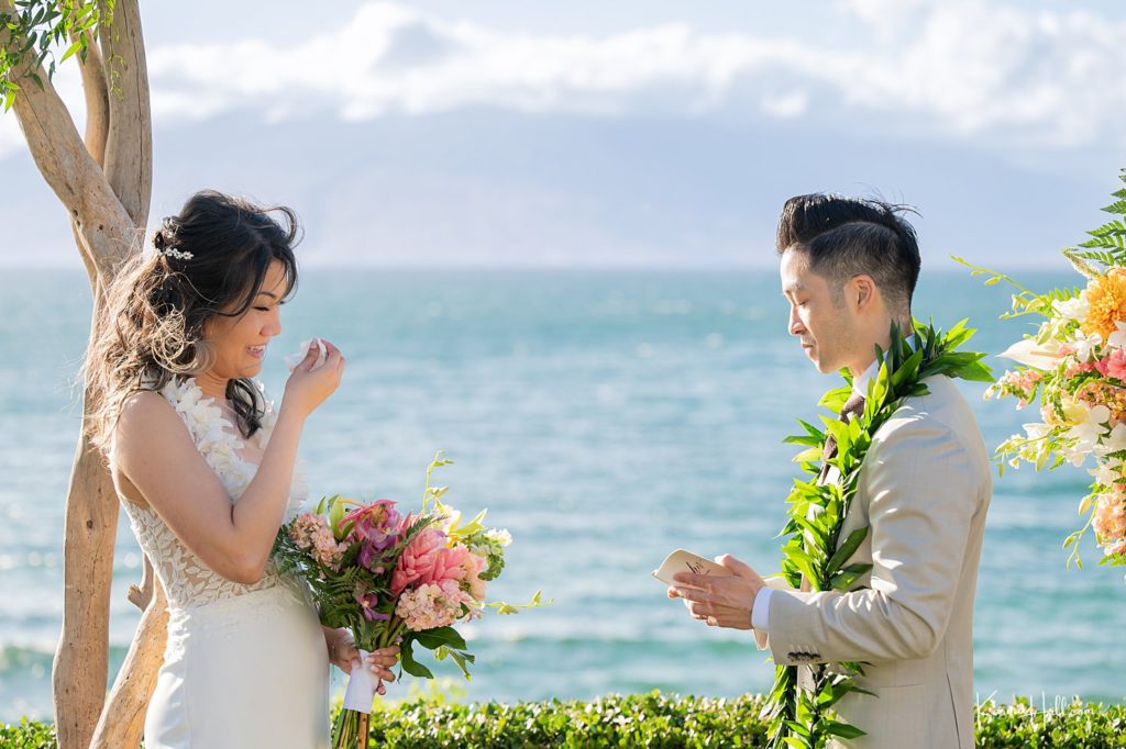 groom exchanging vows with bride at hawaii wedding