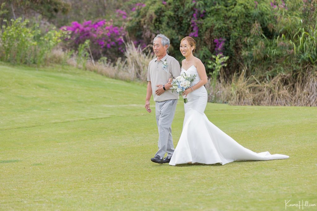 bride walking down the aisle with father