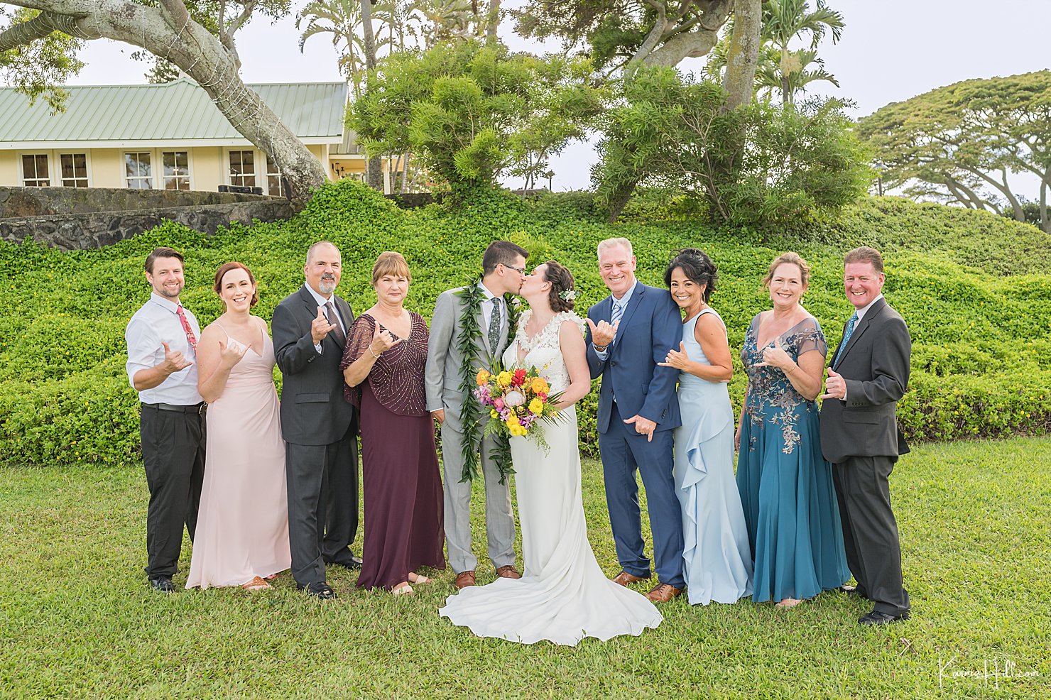 bride and groom with family in maui