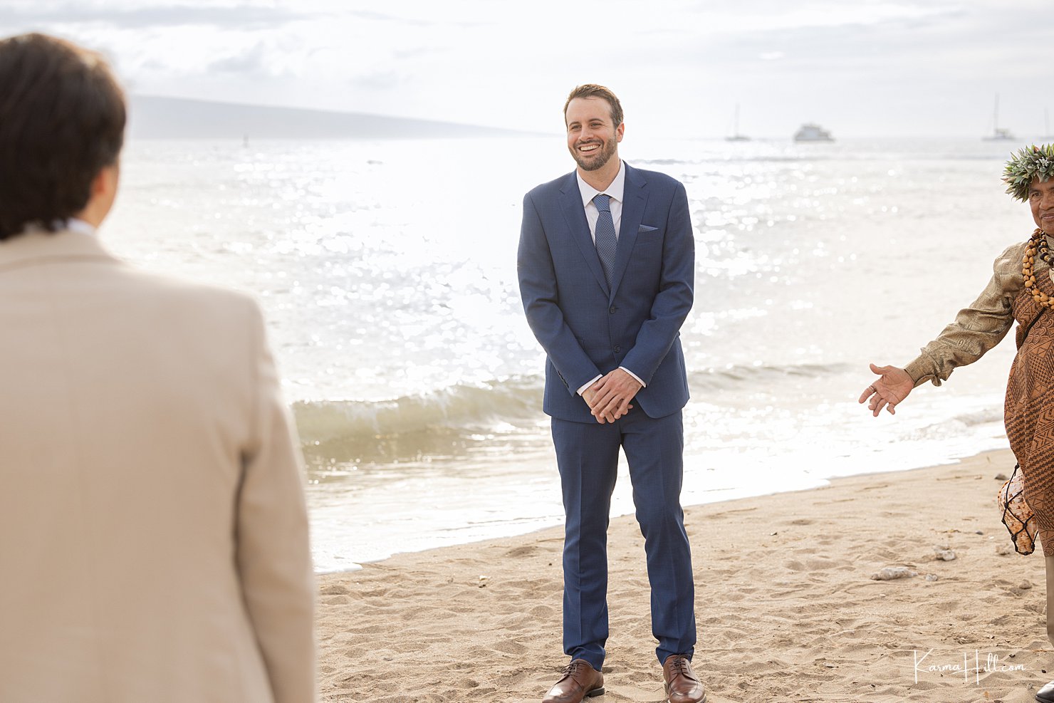A groom sees his bride for the first time during their Hawaii wedding ceremony on the beach.