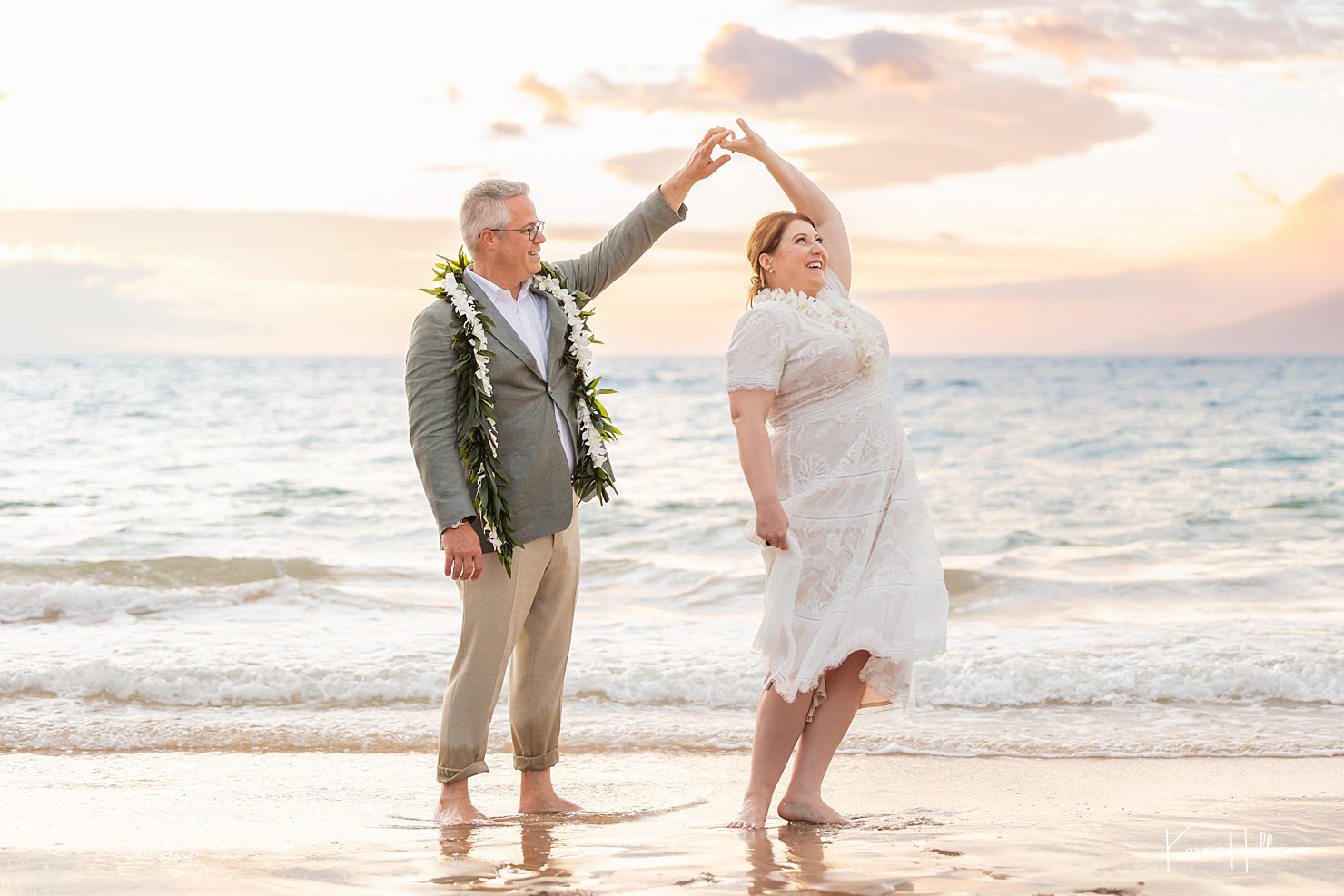 newlyweds dancing on beach 
